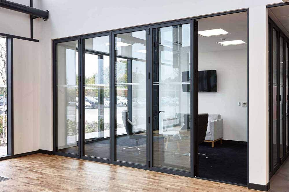 Interior bi fold doors with black frame used for an office